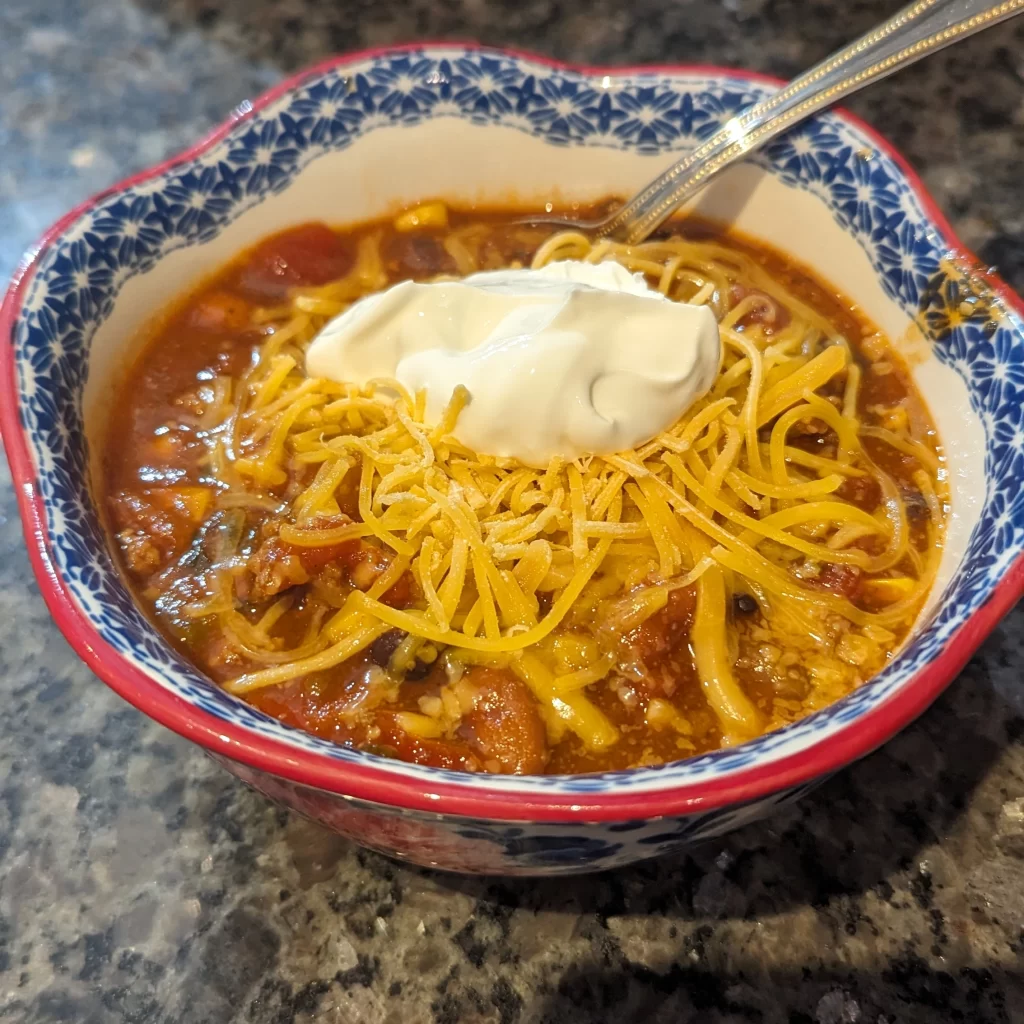 Bowl of Taco Sop with cheese and sour cream on top
